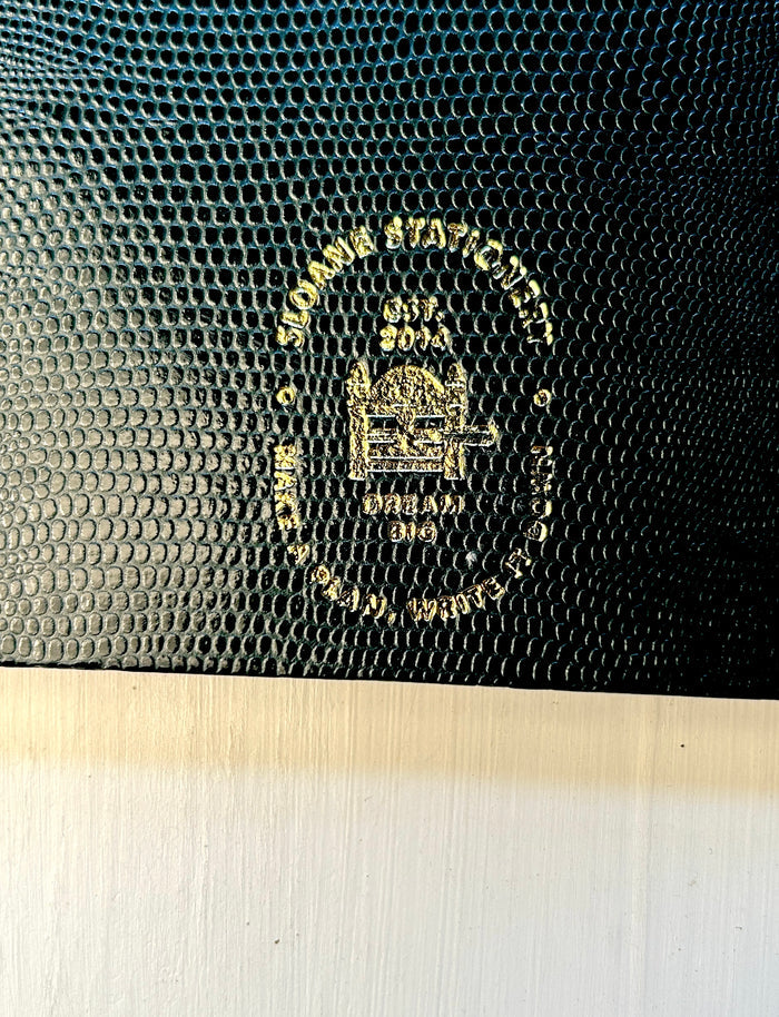 Dark green Sloane Stationery ruled journal with a textured cover and gold foil accents, ideal for home note-taking and journaling.