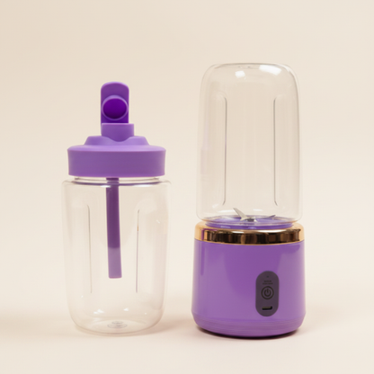 Small portable dual mini blender juicer in purple with cream background