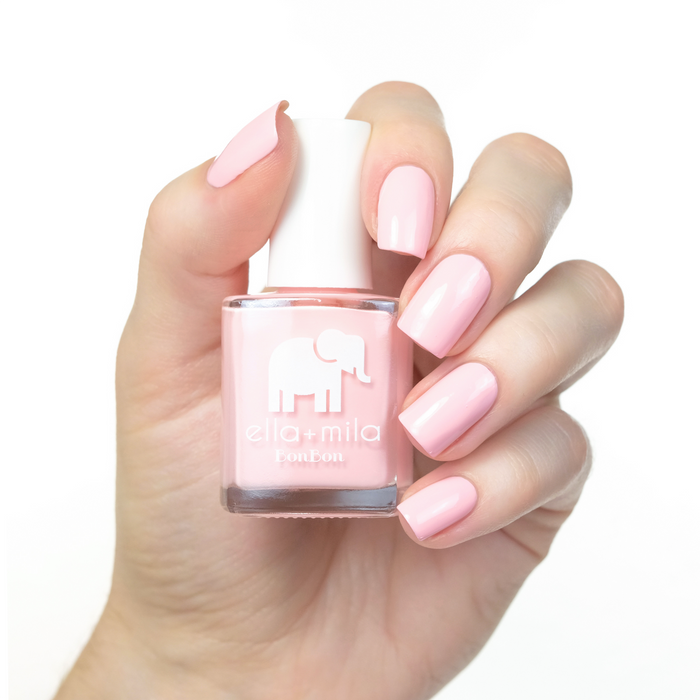 Sugar Puff peach baby pink nail polish manicure on a light skin tone with the bottle