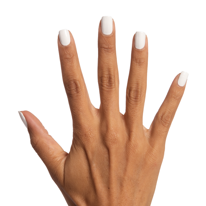 Hand with nails painted in crisp white Swan quick dry polish showing a fresh, clean at-home manicure look