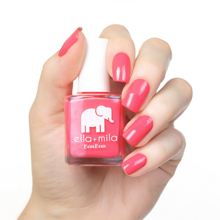 Sweet Tooth peach pink nail polish manicure on a light skin tone with the bottle