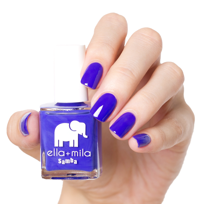 When the Sun Goes Down cobalt blue nail polish manicure on a light skin tone with the bottle