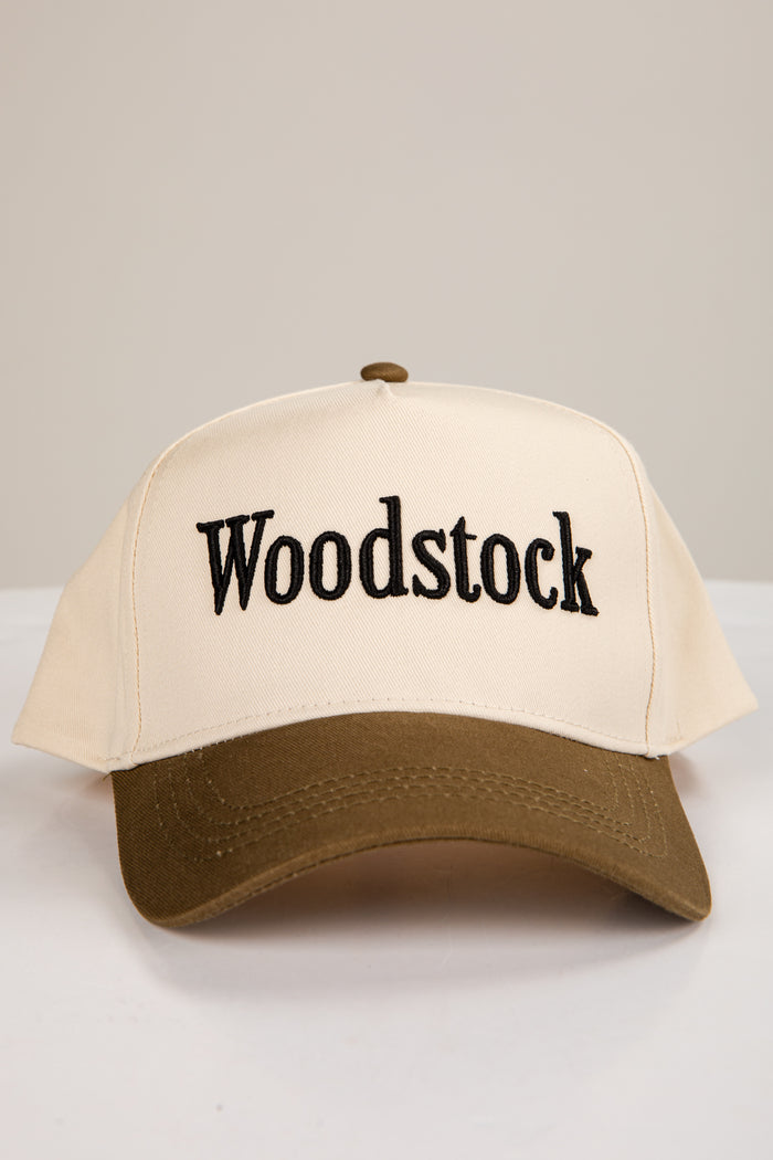 Beige cap with 'Woodstock' text on a white background