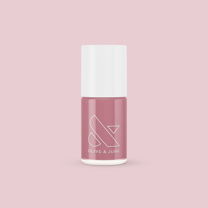 Bottle of Yogurt Parfait nail polish in dusty rose pink shade by Olive and June on light pink background