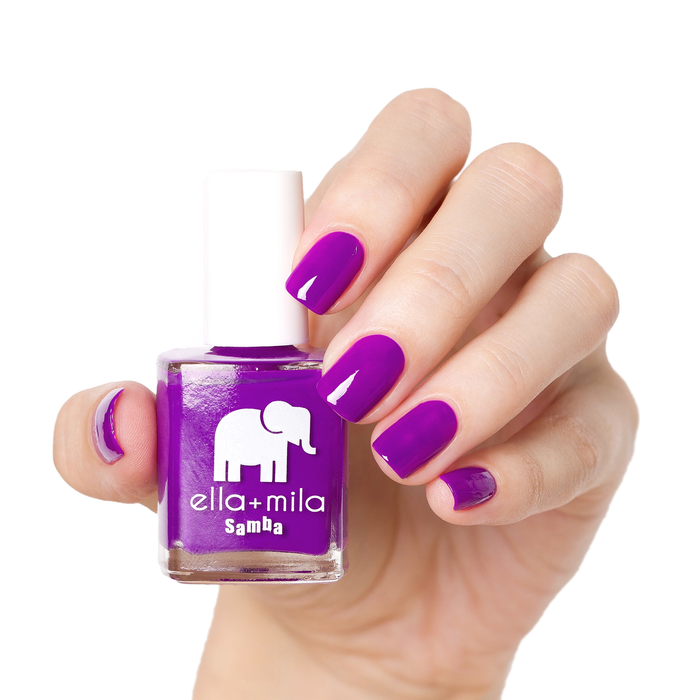 Yours at Dusk bright purple nail polish manicure on a light skin tone with the bottle